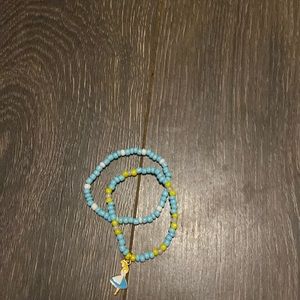 Bracelets I made myself. They’re blue and yellow with a charm and another one.